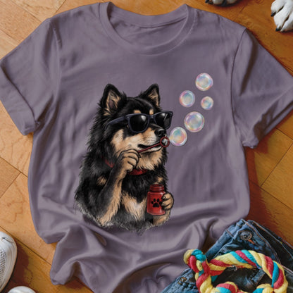 A grey t-shirt featuring a graphic of a black and tan dog wearing sunglasses and blowing soap bubbles.
