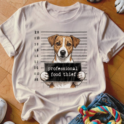 T-shirt graphic of a dog in a police lineup holding a sign that reads "professional food thief".