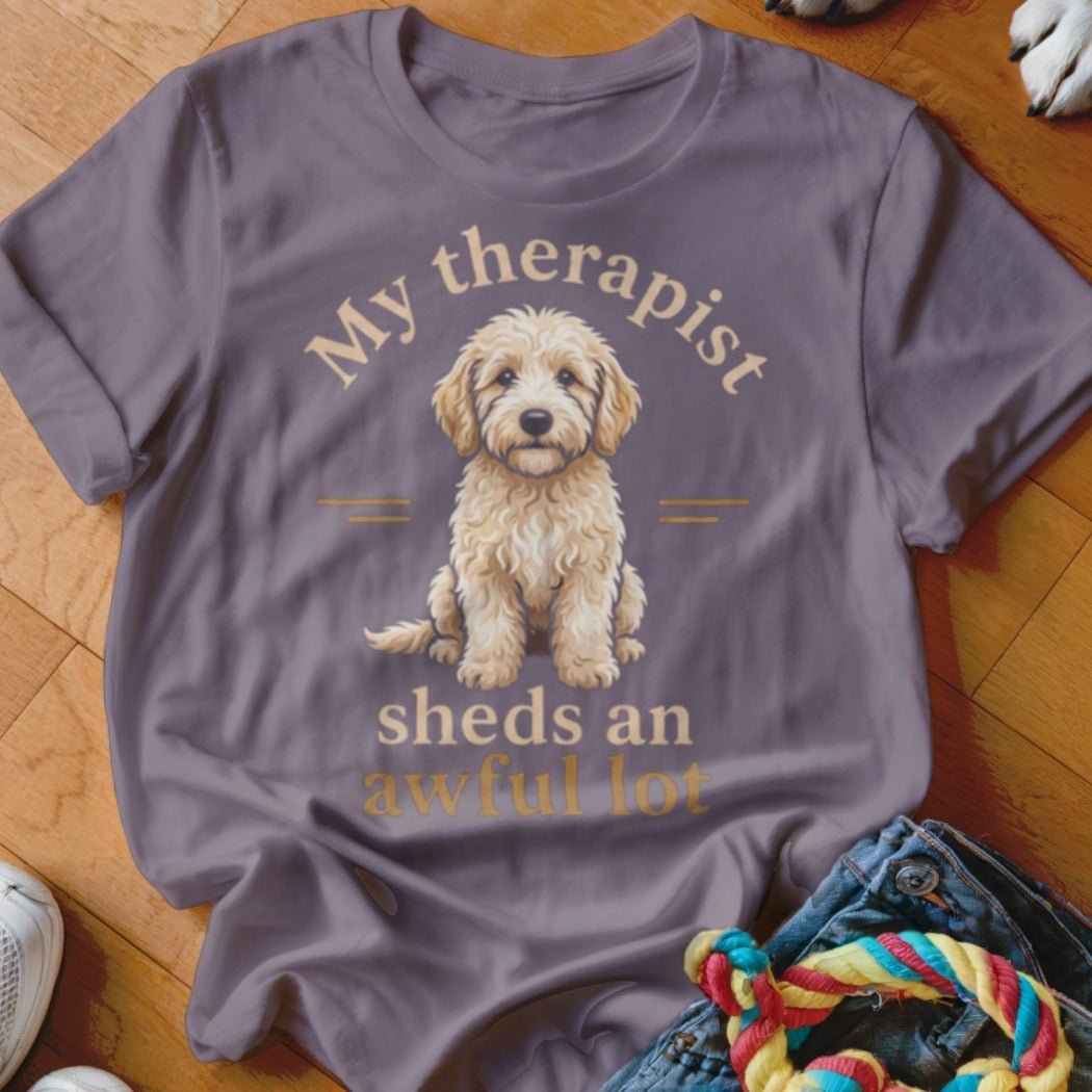 T-shirt with a goldendoodle illustration and text "My therapist sheds an awful lot".
