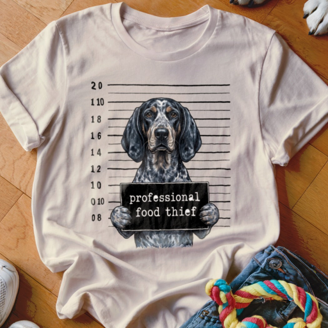T-shirt with a dog mugshot graphic reading "professional food thief".