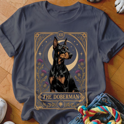 A dark grey t-shirt featuring a tarot card graphic of a Doberman against a moonlit background.