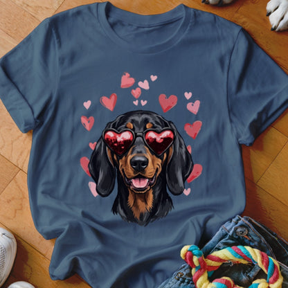 A dark blue t-shirt printed with a dachshund wearing heart-shaped sunglasses surrounded by pink hearts.