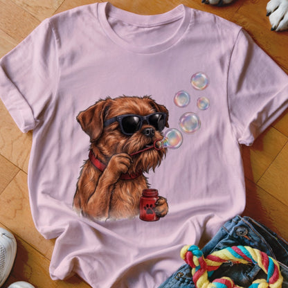 A light pink t-shirt featuring an illustration of a brown dog wearing sunglasses and blowing bubbles.