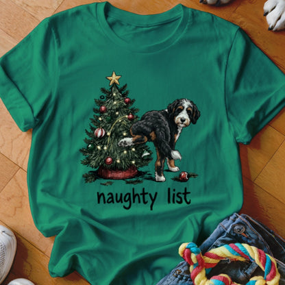 Bernese Mountain Dog near Christmas tree with text "naughty list"