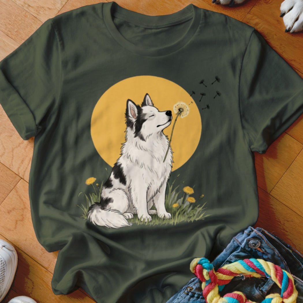 Dark green t-shirt featuring a graphic of a black and white dog sniffing a dandelion.