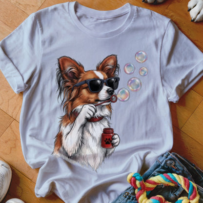 White short-sleeve t-shirt featuring a graphic of a brown and white dog wearing sunglasses blowing bubbles.