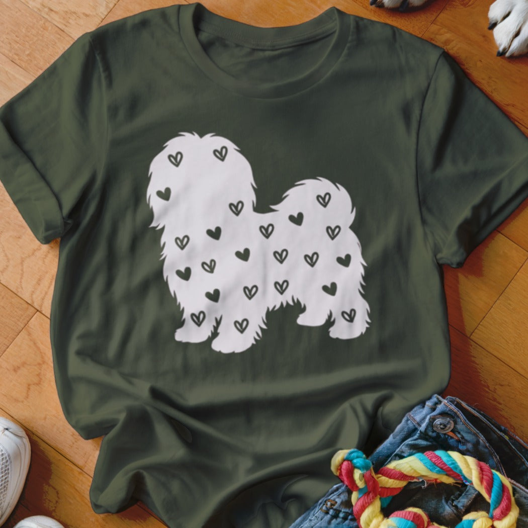 Green t-shirt with a white dog silhouette covered in small black hearts.