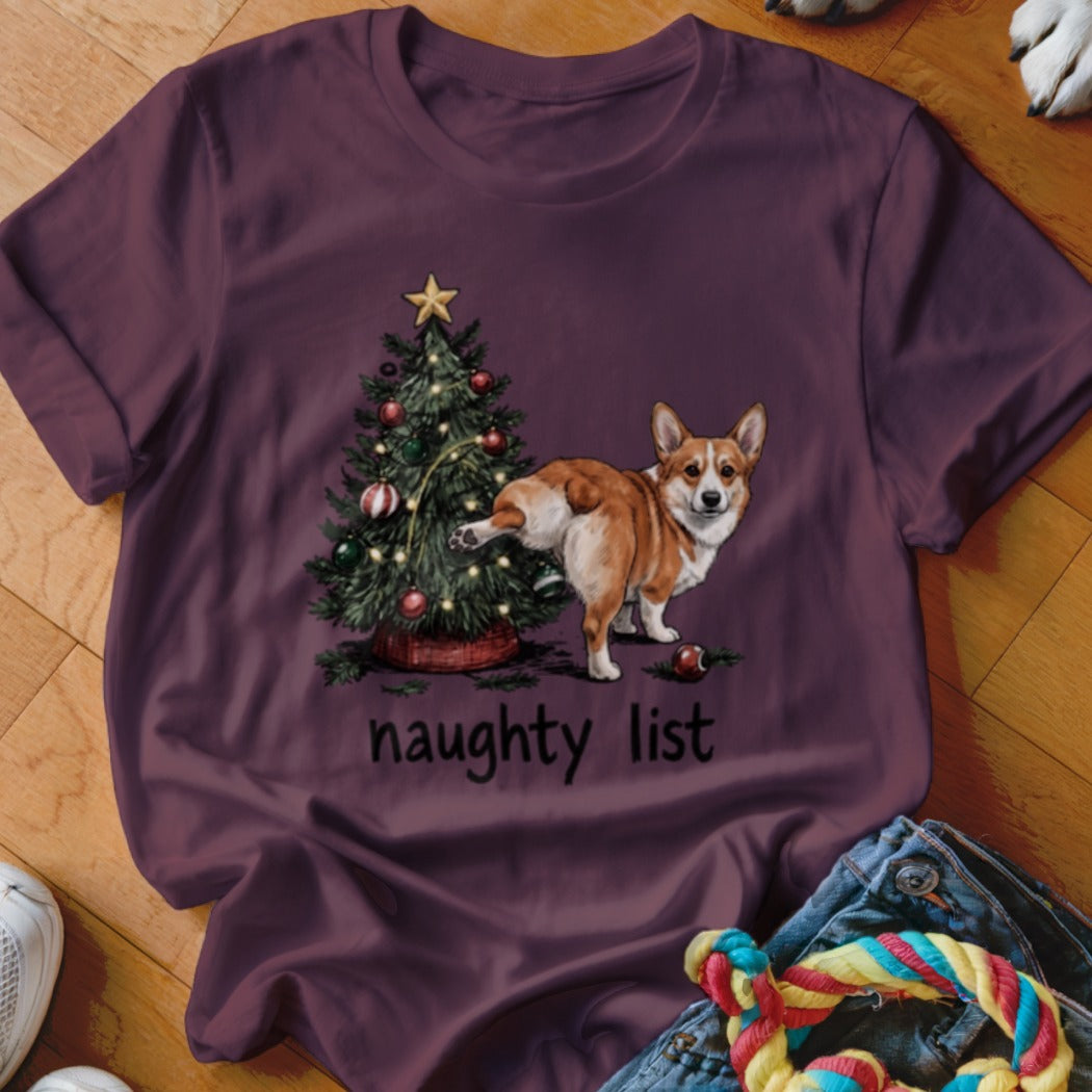 Corgi at Christmas tree with "naughty list" text.