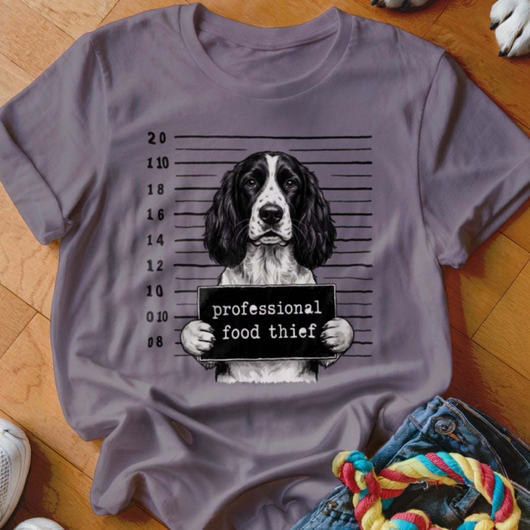 English Springer Spaniel mugshot with "professional food thief" sign.