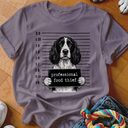 English Springer Spaniel mugshot with "professional food thief" sign.