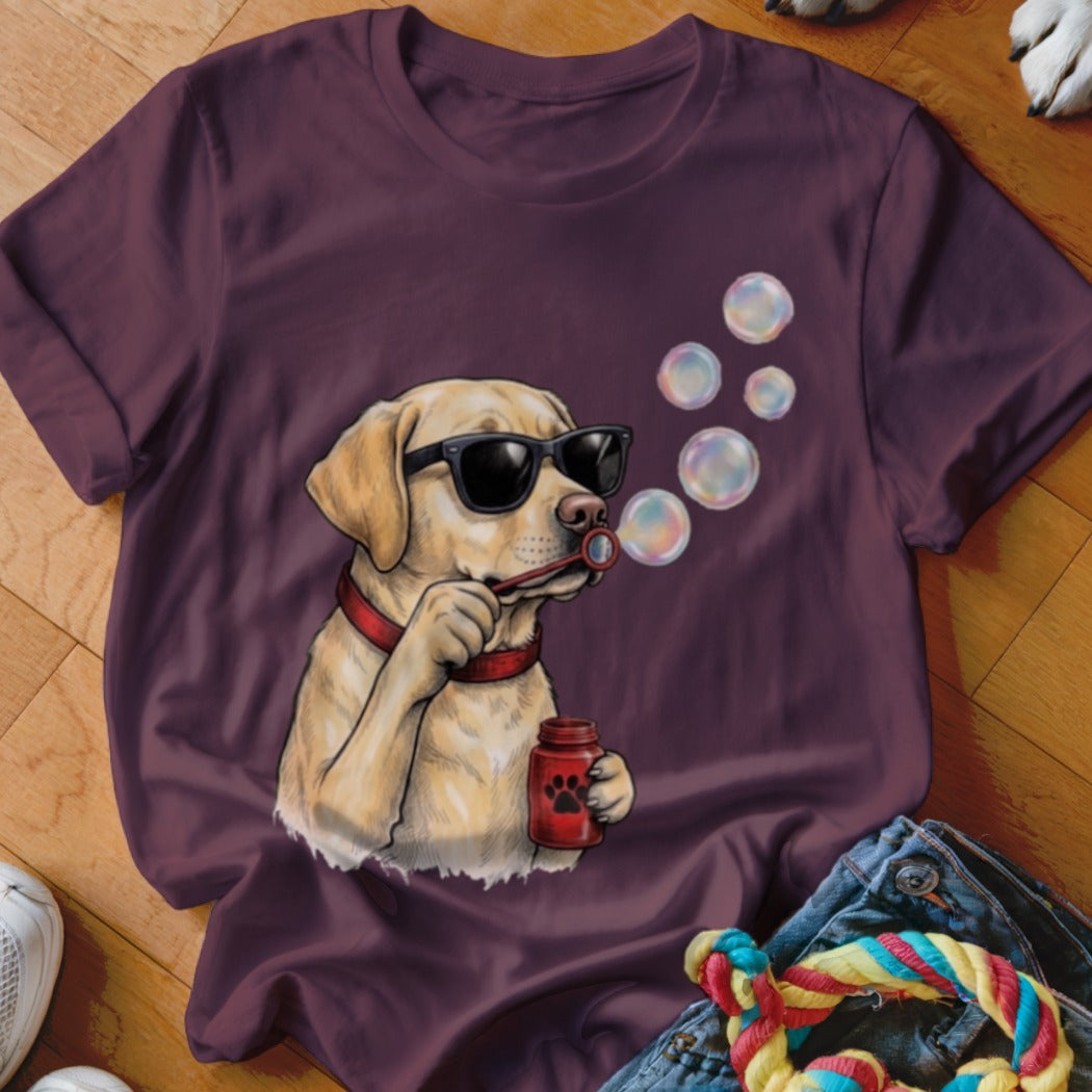 Maroon t-shirt featuring an illustration of a yellow Labrador wearing sunglasses and blowing bubbles.