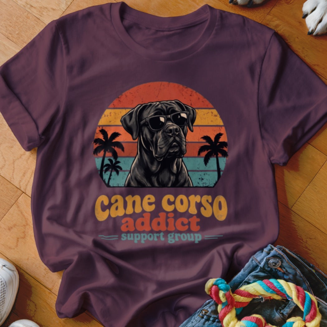 Maroon t-shirt featuring a Cane Corso in sunglasses over a sunset and palm tree graphic with text reading cane corso addict support group.