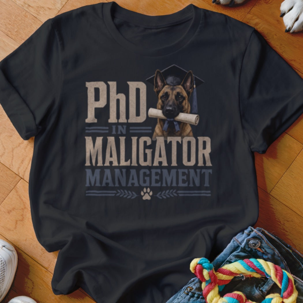 Black t-shirt with a German Shepherd wearing a graduation cap holding a diploma, text reads "PhD IN MALIGATOR MANAGEMENT"