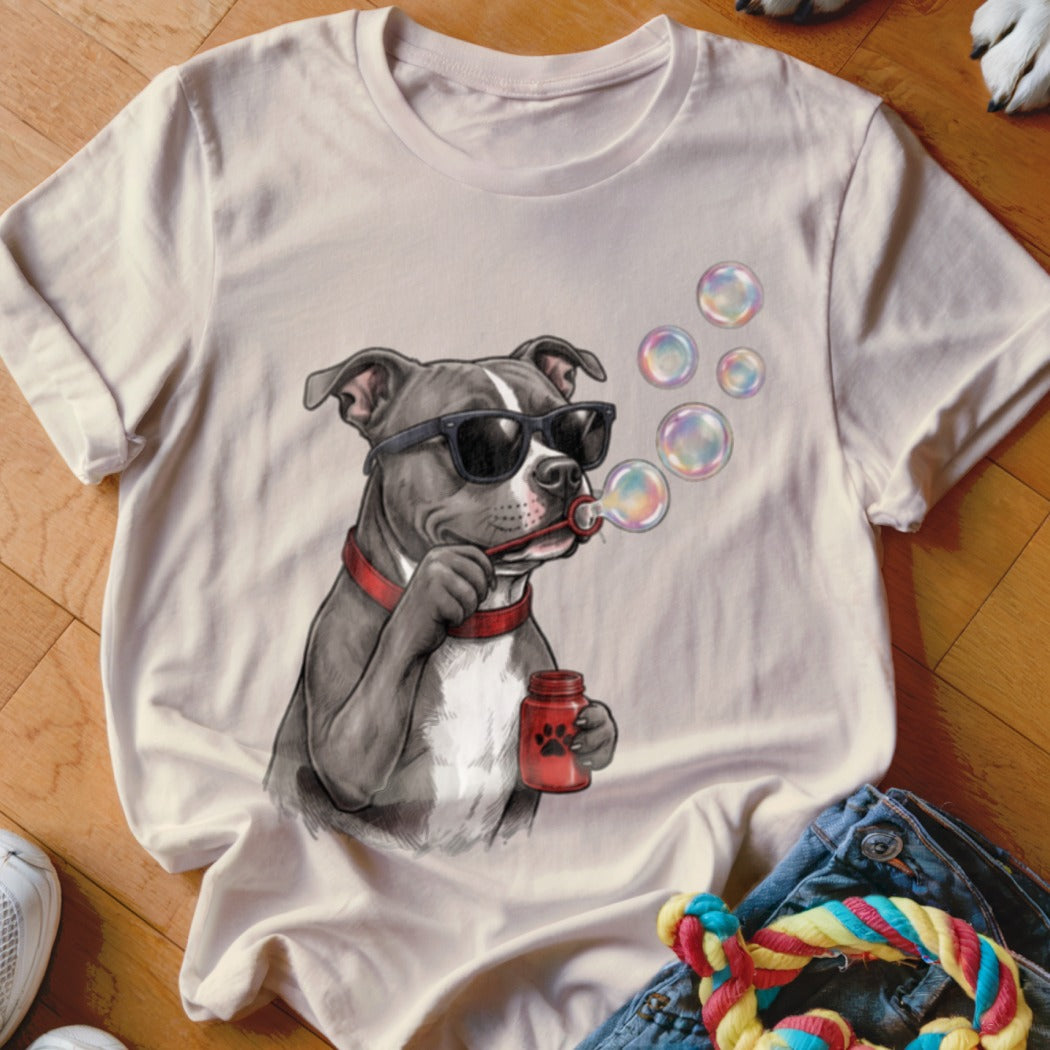 Light beige t-shirt featuring an illustration of a pit bull wearing sunglasses and blowing bubbles.