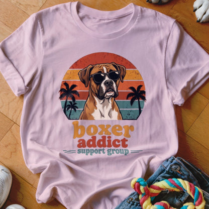 Light pink t-shirt featuring a retro sunset graphic with a Boxer dog wearing sunglasses and palm trees.