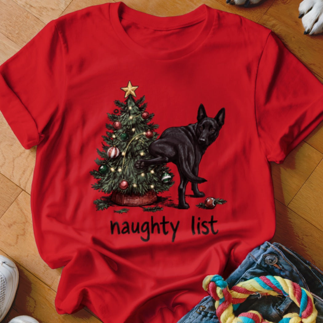 Red t-shirt with a black dog near a Christmas tree and the text "naughty list".