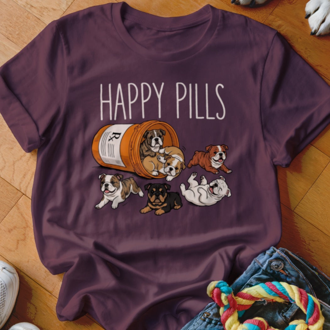 T-shirt with "Happy Pills" text and illustration of bulldog puppies spilling from a prescription bottle.