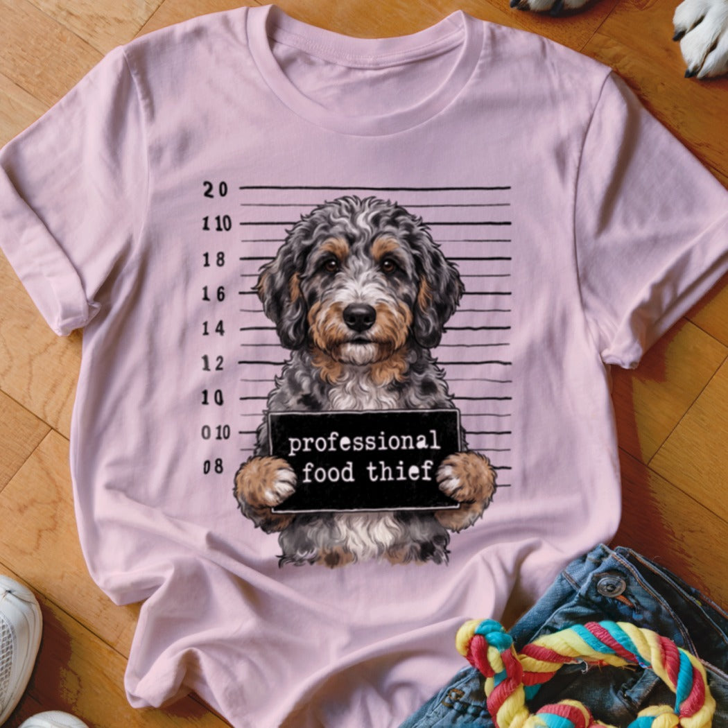 Pink t-shirt with a dog mugshot holding a "professional food thief" sign.
