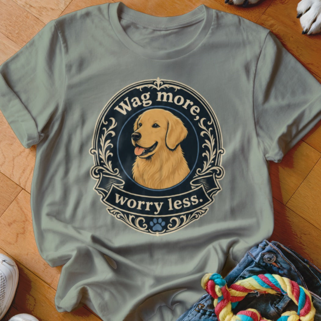 Light grey t-shirt with a circular graphic of a golden retriever and text "Wag more, worry less."