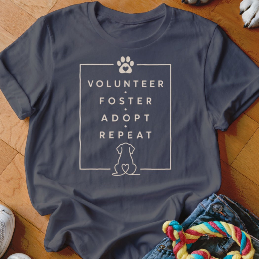 Dark grey t-shirt with "Volunteer Foster Adopt Repeat" and paw print.
