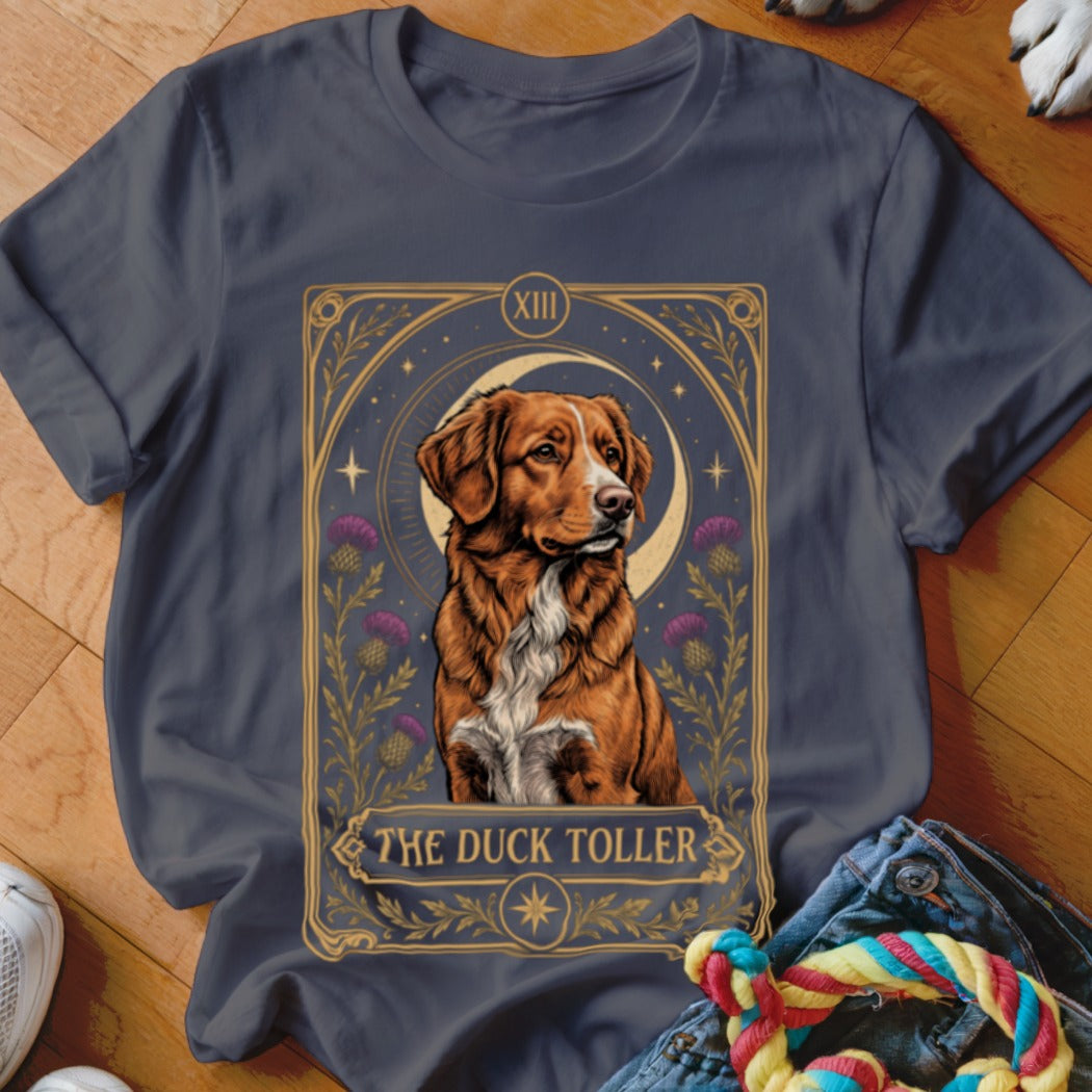 Charcoal grey t-shirt featuring a tarot card graphic of a Nova Scotia Duck Tolling Retriever with text reading The Duck Toller.
