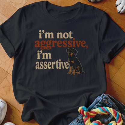 Dark t-shirt with text "i'm not aggressive, i'm assertive" and a dog graphic.