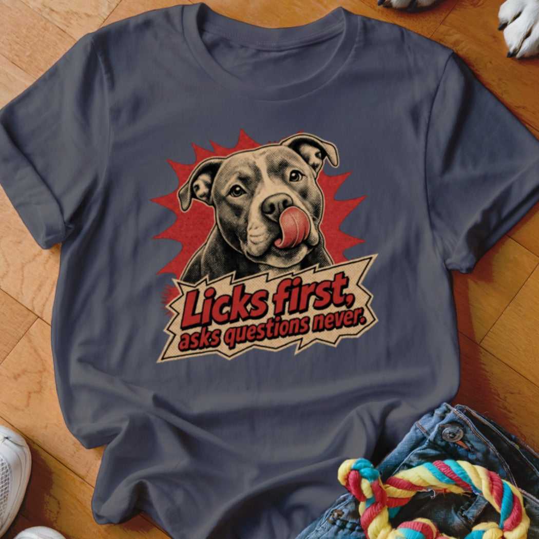 T-shirt with a pit bull licking its nose and the text "Licks first, asks questions never."