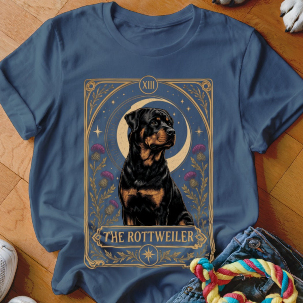 Blue t-shirt featuring a tarot card graphic of a Rottweiler with flowers, stars, and crescent moon.