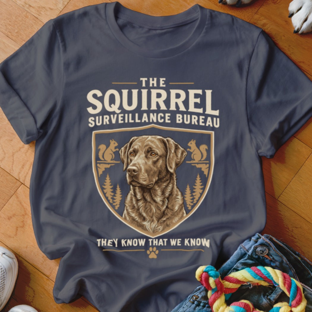 Dark gray t-shirt with a graphic of a brown dog and text reading The Squirrel Surveillance Bureau.