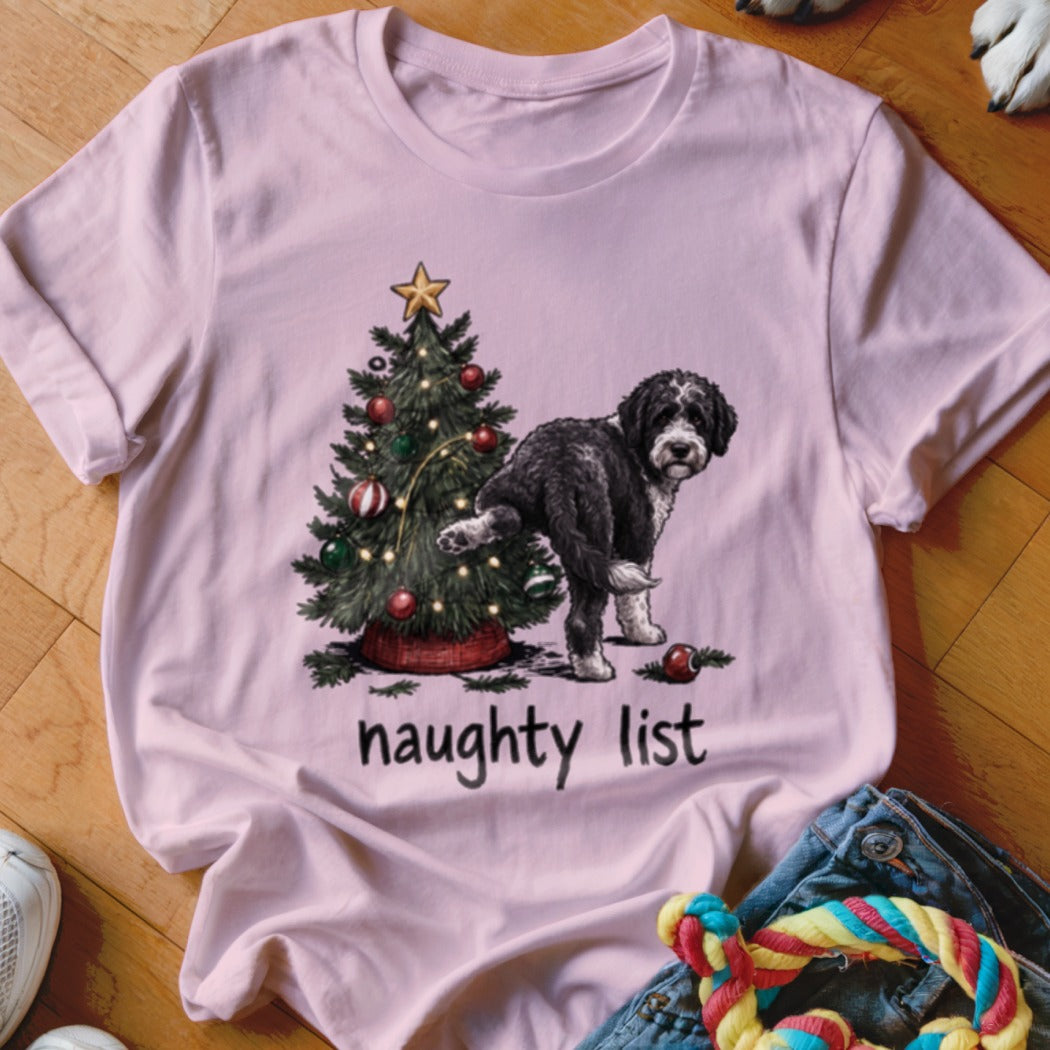 Light pink t-shirt with a Christmas tree and dog graphic, "naughty list" text.
