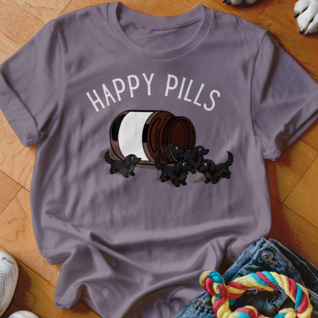 T-shirt with "HAPPY PILLS" text and illustration of dachshund puppies spilling from a bottle.