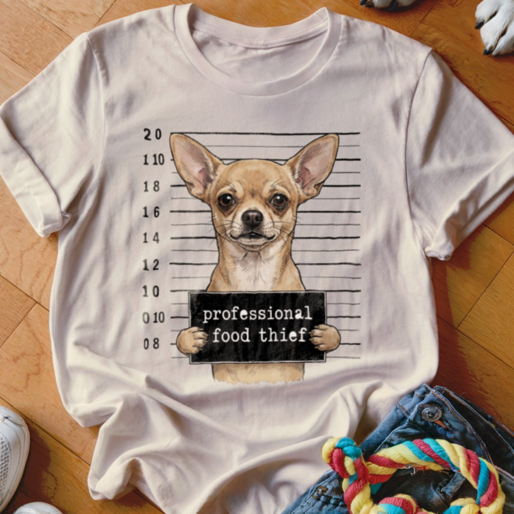 Chihuahua mugshot with text "professional food thief" on a t-shirt.