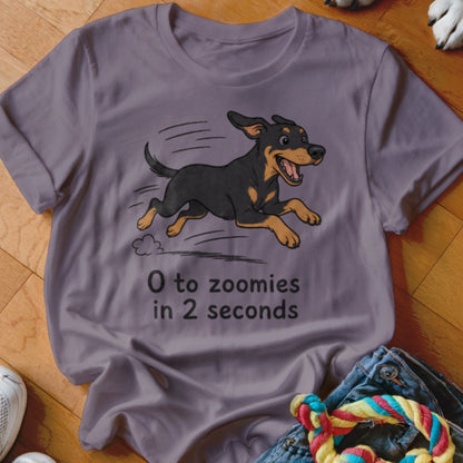 Purple t-shirt with cartoon dog running and text "0 to zoomies in 2 seconds".
