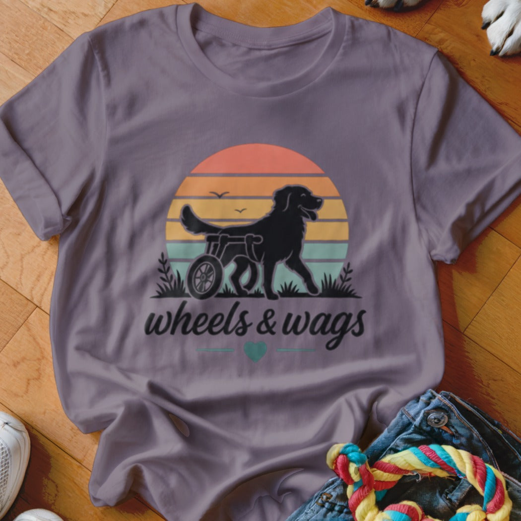 Black dog in a wheelchair with "wheels & wags" text below a sunset.