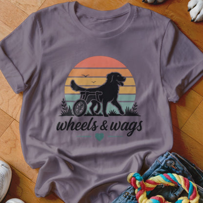 Black dog in a wheelchair with "wheels & wags" text below a sunset.