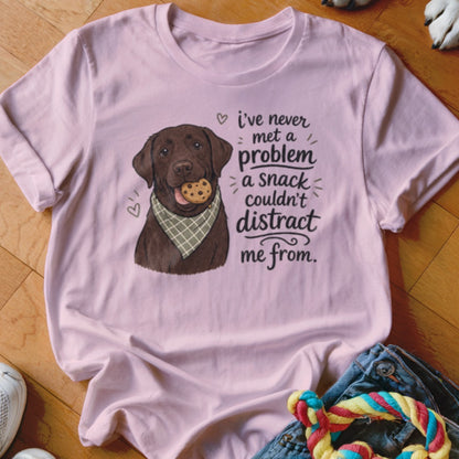 Pink t-shirt with chocolate lab wearing bandana and cookie, text reads "i've never met a problem a snack couldn't distract me from."