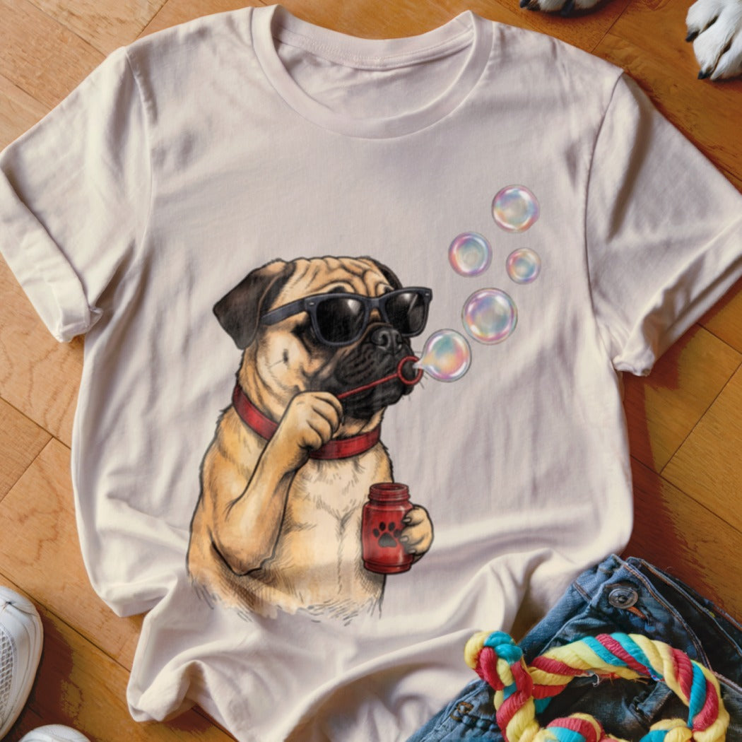 Cream crewneck t-shirt featuring a graphic of a pug wearing sunglasses and blowing soap bubbles.