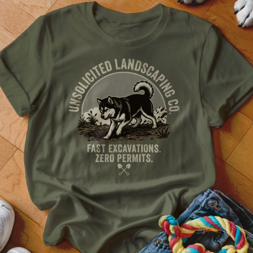 Green t-shirt with graphic of dog digging, text "Unsolicited Landscaping Co." and "Fast Excavations. Zero Permits."