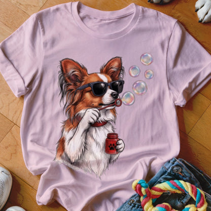 Light pink t-shirt featuring a graphic of a brown and white dog wearing sunglasses and blowing soap bubbles.