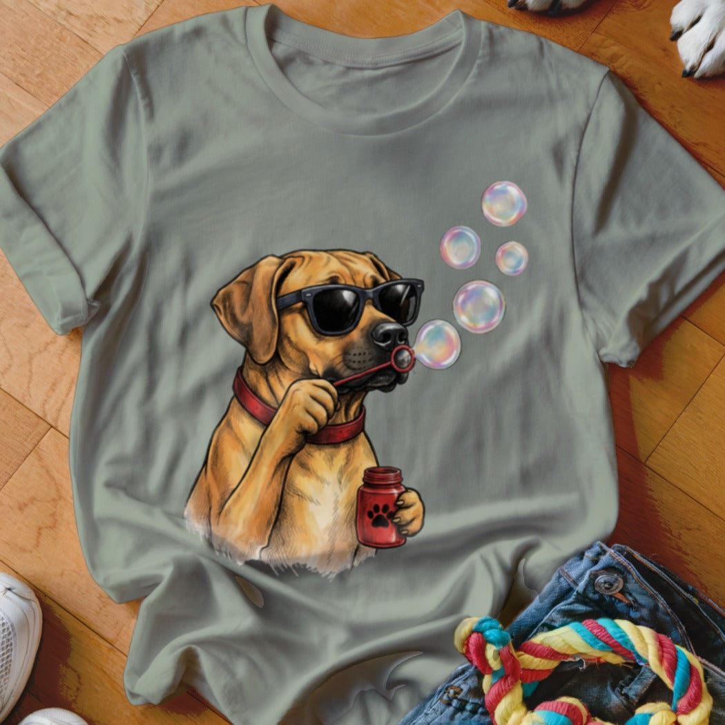 Sage green t-shirt featuring a cartoon dog in sunglasses blowing soap bubbles.