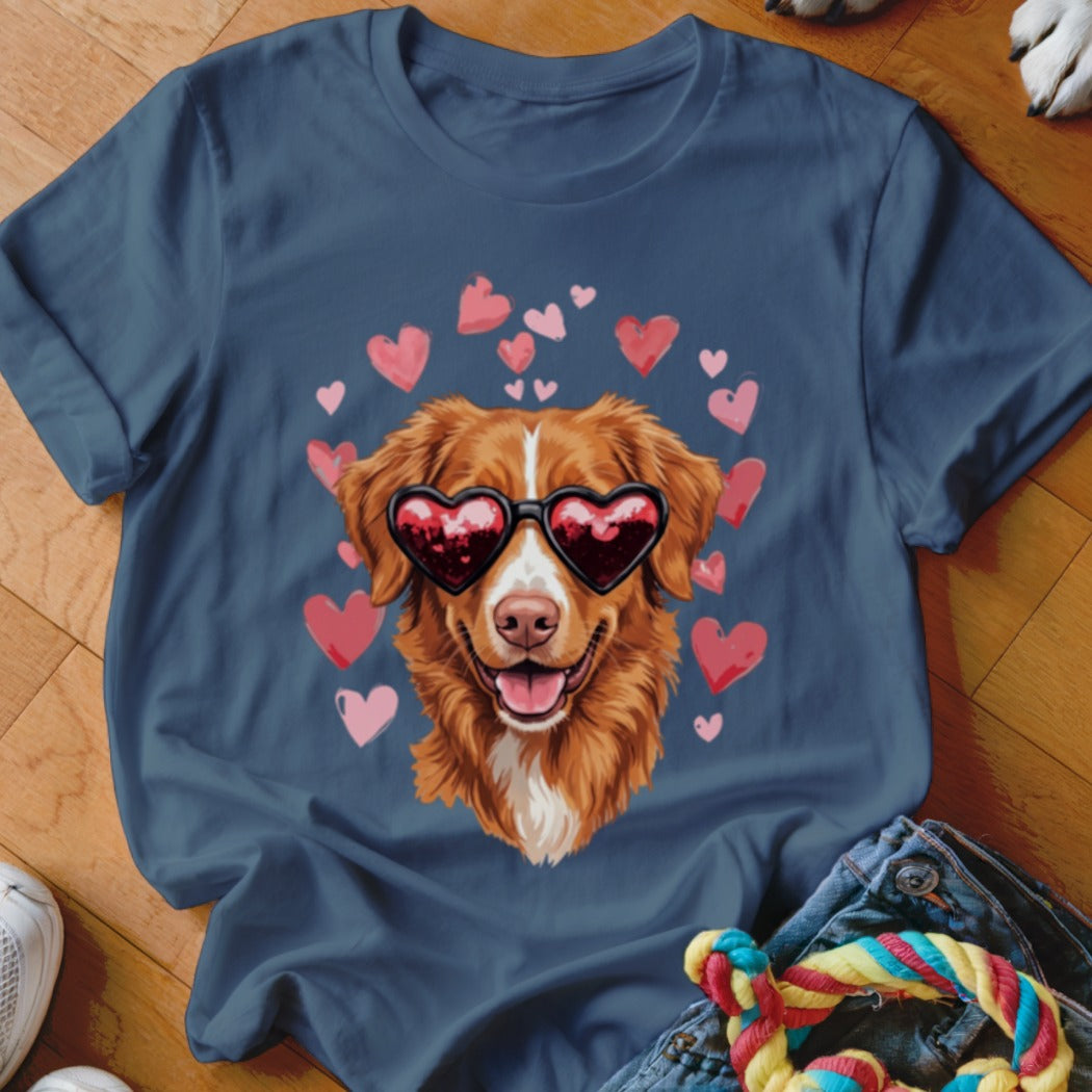 Dark blue t-shirt featuring a graphic of a golden dog wearing heart-shaped sunglasses surrounded by pink hearts.