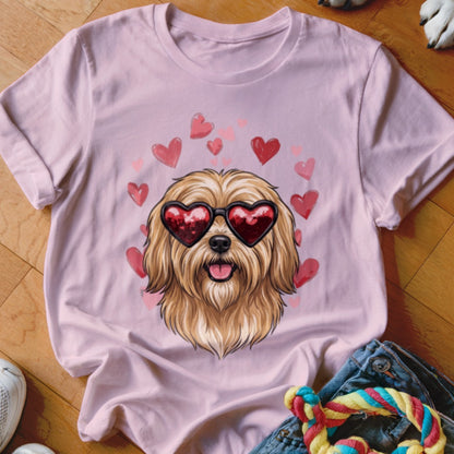 Pink t-shirt featuring an illustrated shaggy dog wearing heart sunglasses surrounded by floating red hearts.