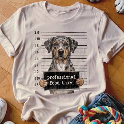 White t-shirt with a dog in a mugshot holding a sign: "professional food thief."
