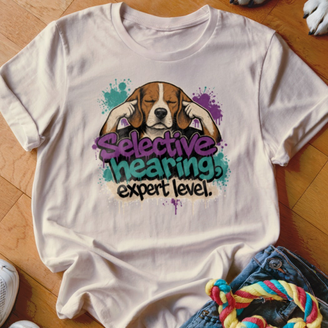 Beagle with eyes closed covering ears, text "Selective hearing expert level".