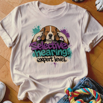 Beagle with eyes closed covering ears, text "Selective hearing expert level".