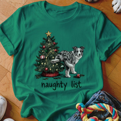 Green t-shirt with a Border Collie dog lifting its leg near a Christmas tree, "naughty list" text.