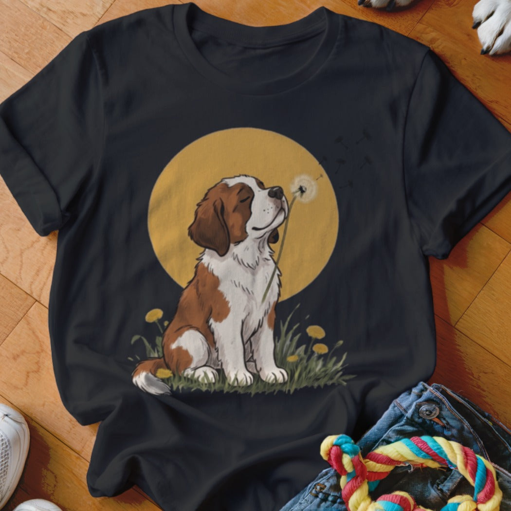 A black crewneck t-shirt featuring an illustration of a brown and white dog blowing a dandelion.