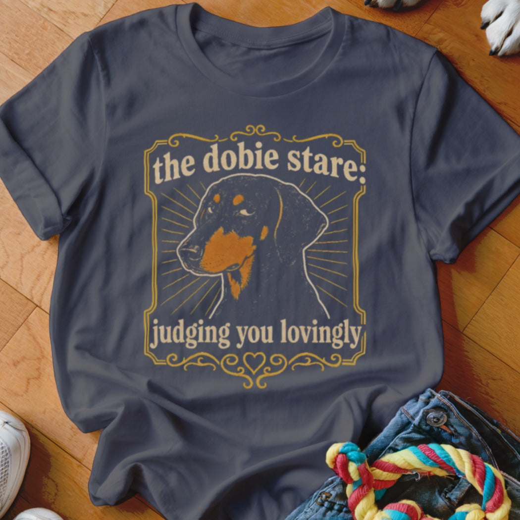 Dark grey t-shirt with a Doberman graphic and text "the dobie stare: judging you lovingly".