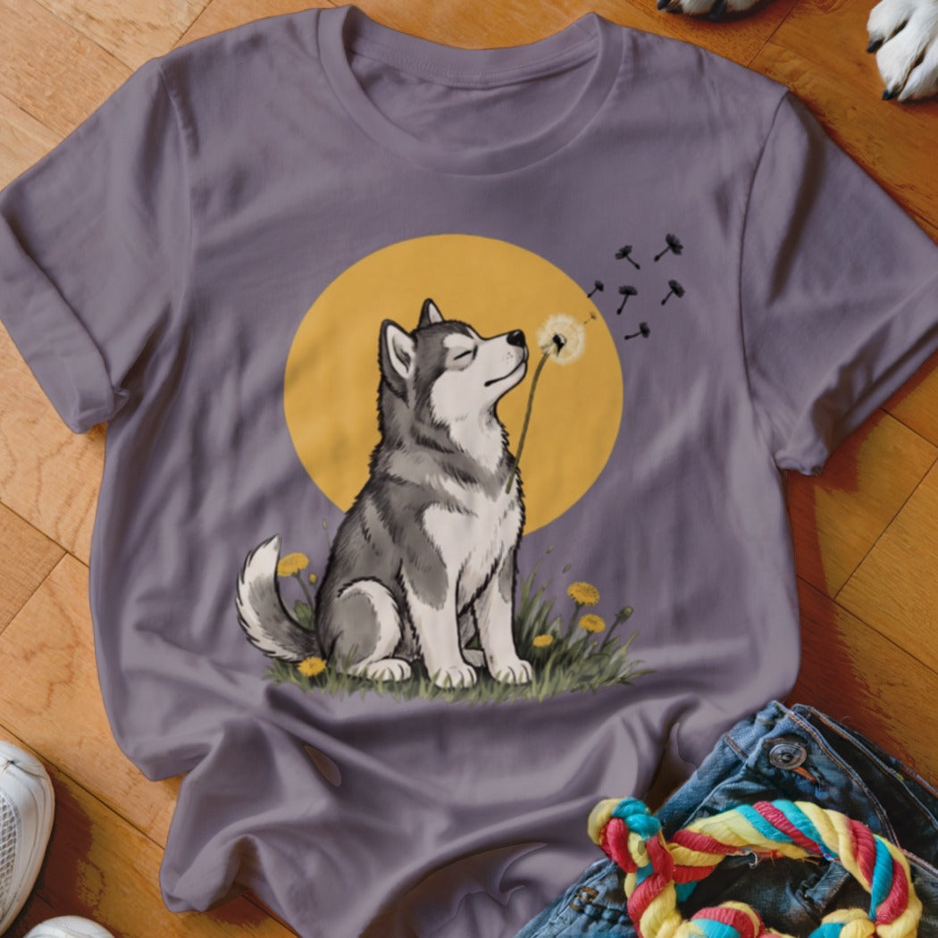 A gray crewneck t-shirt featuring a cartoon illustration of a husky sniffing a dandelion against a yellow circle.