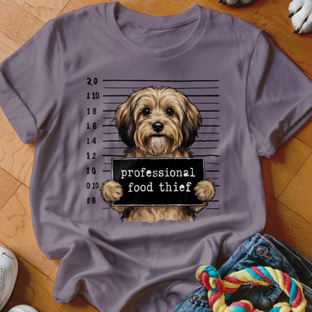 T-shirt with a dog mugshot holding a "professional food thief" sign.